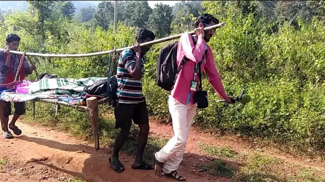 సరిగట్ట గ్రామస్తులతో కలసి డోలీ మోస్తున్న జర్నలిస్టు దేబీ మెయిటీ