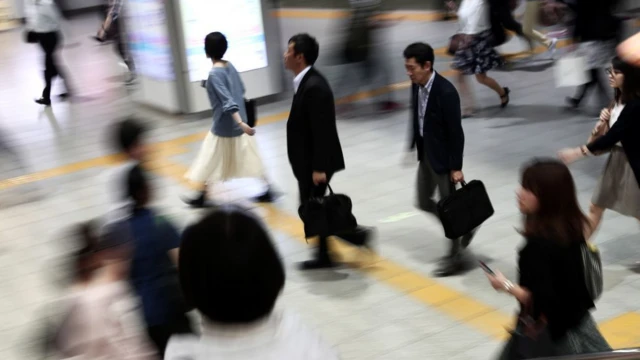 People walking at a Japanese train station