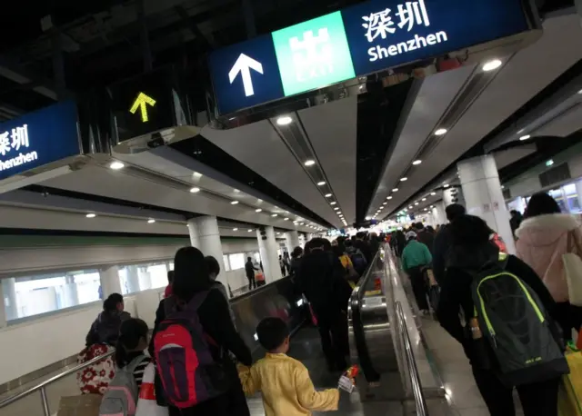 Travellers crossing the border to Shenzhen at the Lo Wu border