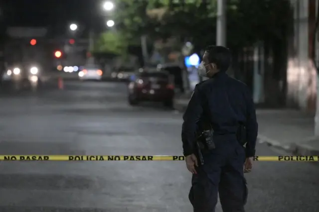 Un policía en una zona acordonada tras el asesinato de un hombre a manos de un presunto pandillero en Colón, La Libertad, El Salvador, el 26 de marzo de 2022.