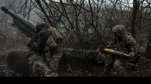 National Guard of Ukraine soldiers fire a howitzer towards Russian troops in Donetsk region