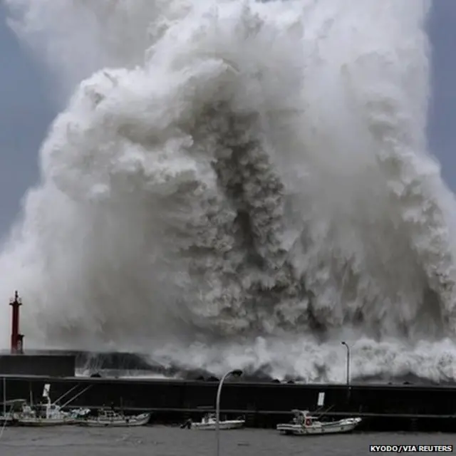 High waves breaking at a fishing port in Aki