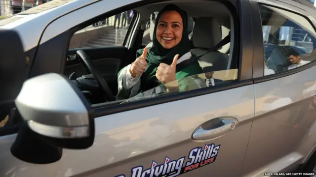 A Saudi woman poses for a photo after having a driving lesson in Jeddah on March 7, 2018