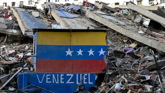 Edificio destruido en Caraballeda, La Guaira. En el primer plano una muralla destruida que dice Venezuela.