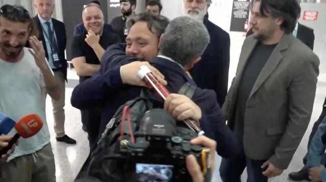 Italian lawmaker Dario Carotenuto is embraced by a relative 