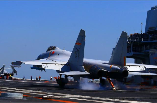 This photo taken on April 24, 2018 shows a J15 fighter jet landing on China's sole operational aircraft carrier, the Liaoning, during a drill at sea. - A flotilla of Chinese naval vessels held a 'live combat drill' in the East China Sea, state media reported early April 23, 2018, the latest show of force by Beijing's burgeoning navy in disputed waters that have riled neighbours. (Photo by - / AFP) / China OUT (Photo credit should read -/AFP/Getty Images)