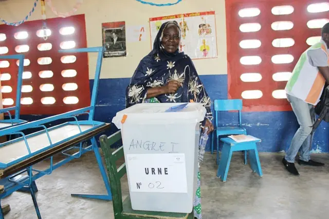 Une femme portant un voile sur la tete, met son enveloppe dans l'urne, à Abidjan en Cote d'Ivoire. 
