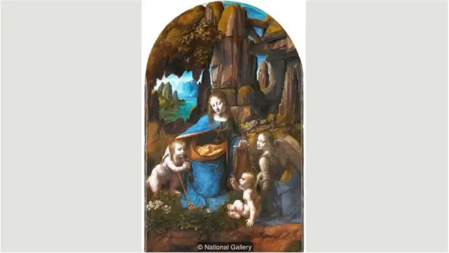 Dalam lukisan yang dianggap sebagai versi kedua, Da Vinci menambahkan lingkaran halo dan melukis Yohanes Pembaptis dengan salib.