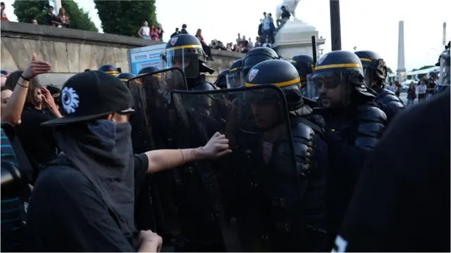 A protester clashes with police during unrest in Paris