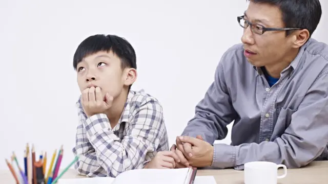 Father trying to teach his son