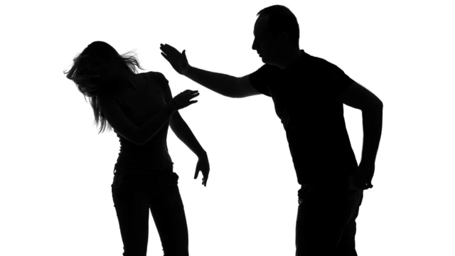silhouette of man beating woman