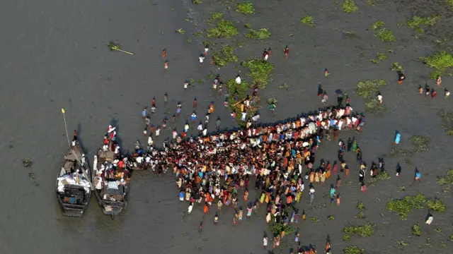 সাইক্লোন সিডরে ফসলের জমিতে ঢুকে পড়ে নোনা জল। এখানে নদীর ঘাটে রিলিফের নৌকার কাছে সাহায্যপ্রার্থীদের ভিড়।