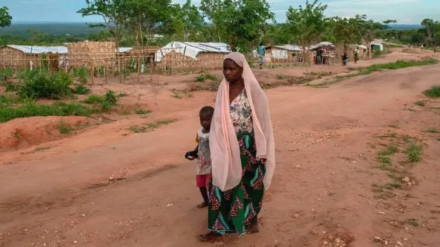 A woman and her child walk in the community of Ntocota, Metuge District in Pemba, Cabo Delgado Province on February 22, 2021