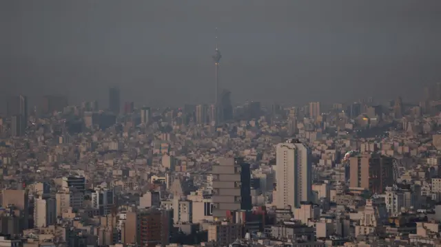 Hazy skyline picture of Tehran on the morning after the strikes