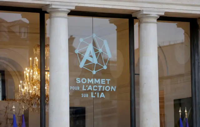 The logo of the "Artificial Intelligence Action Summit" is displayed on the exterior wall of the Elysee Palace in Paris, France