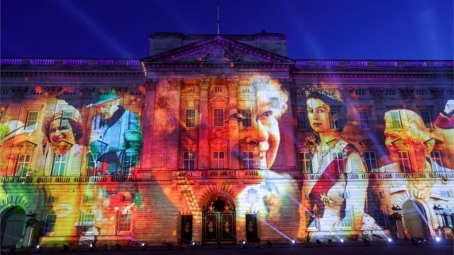 Buckingham palace with Queen's faces on