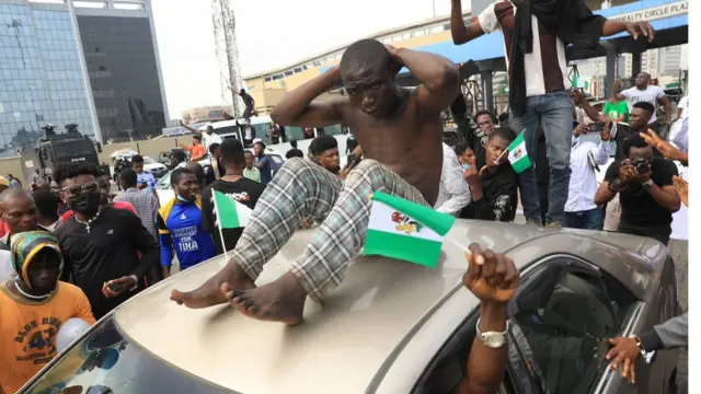 End SARS Protester ontop car dey demonstrate