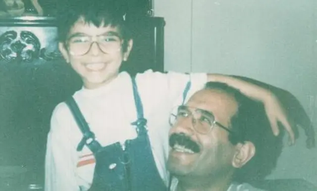 Sohrab sits with his father Mohammad Mokhtari