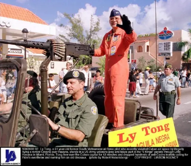 Ly Tong stands in a US Army veterans jeep and takes part in the '3 Kings' parade through Little Havana in Miami