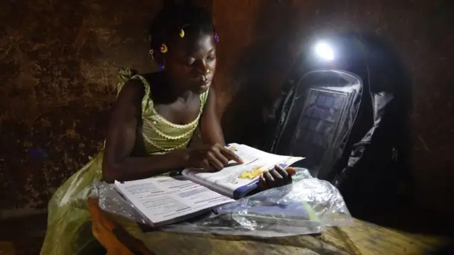 Ivory Coast school girl dey read her books