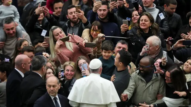 Pope Francis greets the audience