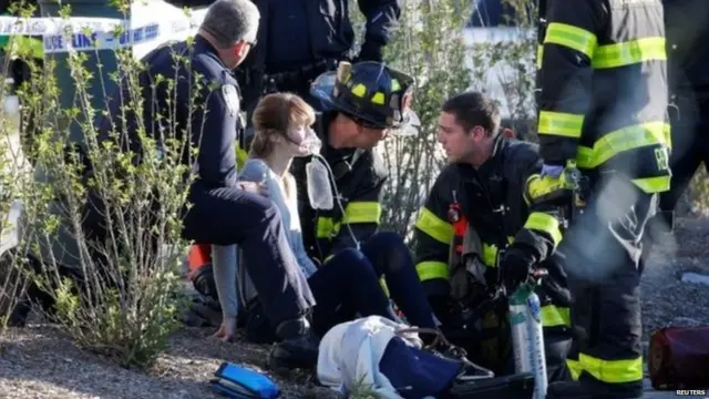 An injured woman is treated by first responders.