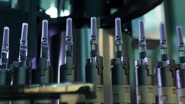 Vaccines vials on an assembly line
