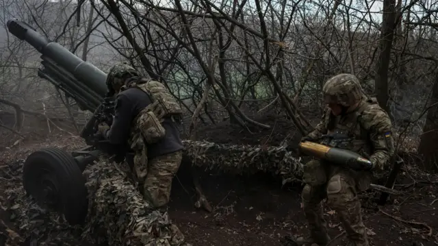 National Guard of Ukraine soldiers fire a howitzer towards Russian troops in Donetsk region