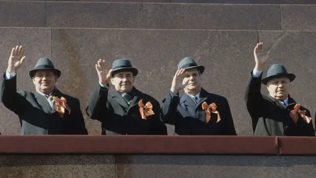 Генеральный секретарь СССР Михаил Горбачев, Председатель Президиума Верховного Совета СССР Андрей Громыко, Председатель Совета Министров СССР Николай Рыжков, член Политбюро ЦК СССР Егор Лигачев (ЛП) приветствуют собравшихся с трибуны Политбюро СССР.