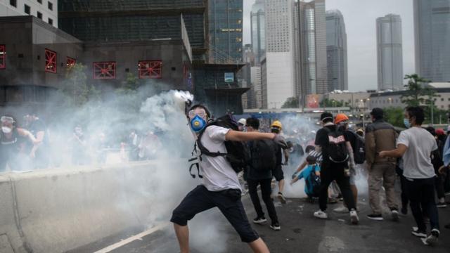 A Protester throws back the tear gas during a protest against a proposed extradition law on June 12, 2019 in Hong Kong, Hong Kong.