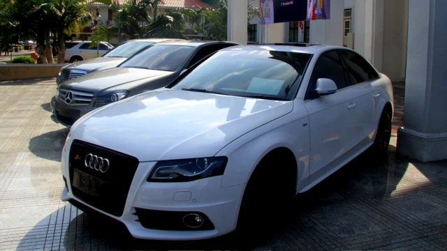 Photo of some luxury cars in a park