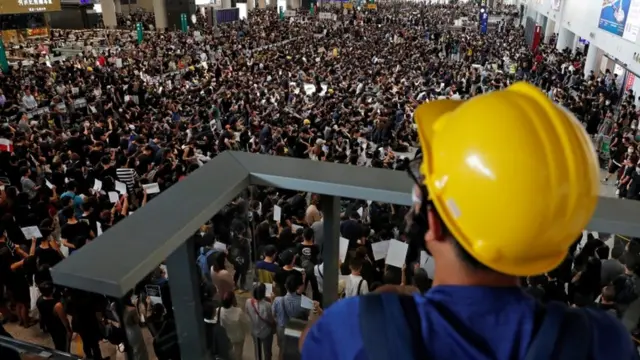 Anti-extradition bill protesters attend a mass demonstration after a woman was shot in the eye during a protest at Hong Kong International Airport, i