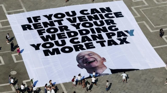 Protest banner by Venice Locals wey no want Jeff Bezos wedding to hold for di city.