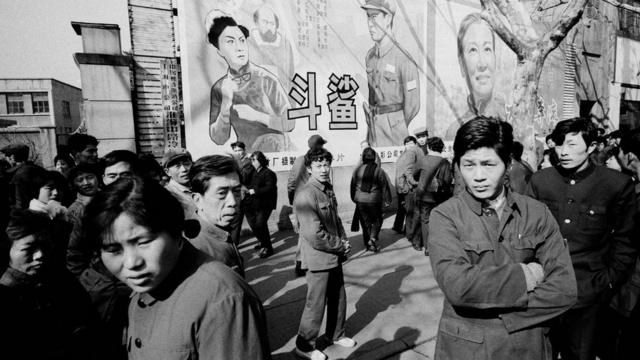 A crowd of people in front of movie posters in February 1979 in Shanghai, China.