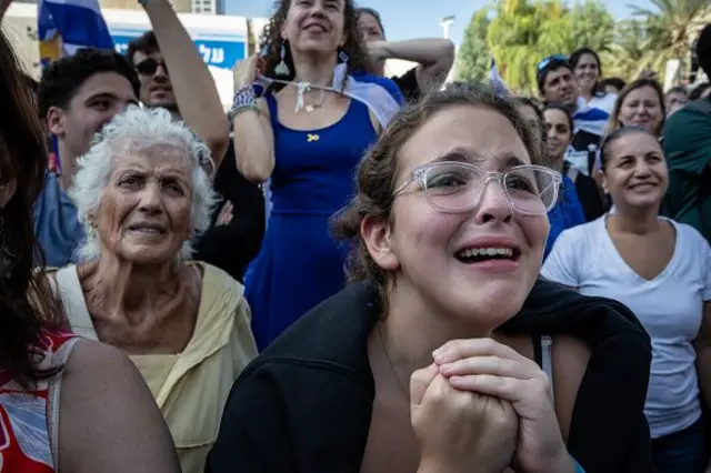 A woman cries while watching the hostage release live stream at Hostages Square on October 13, 2025 in Tel Aviv, Israel. 