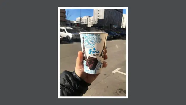 ‘사랑해 파리’가 적힌 커피컵을 손에 든 모습