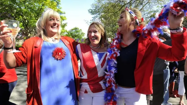 Revellers cheer with Britain's Union flags during a street party to celebrate the Queen's Diamond Jubilee in Edinburgh on 3 June 2012