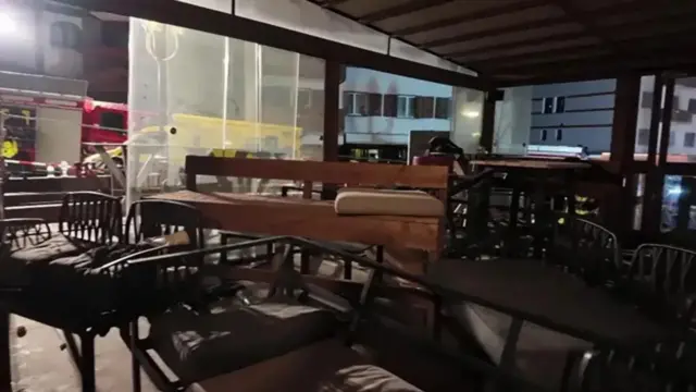 Police don release fotos from inside di bar afta di fire show chairs and benches wey scata across di room