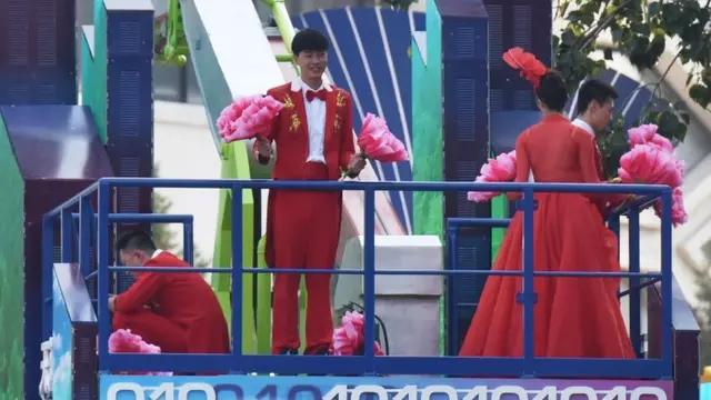 People on a float rehearse for the civil parade