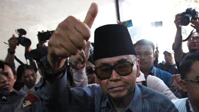 Pimpinan Pondok Pesantren Al Zaytun Panji Gumilang (tengah) berjalan saat akan menjalani pemeriksaan di Bareskrim Mabes Polri, Selasa (01/08).