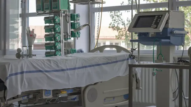 Leito de UTI ao lado de aparelhos e ventilador mecânico
