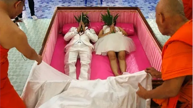 couple getting married in a coffin