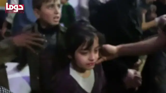 Children are given medical checks in what is said to be the rebel-held Syrian town of Douma, 7 April