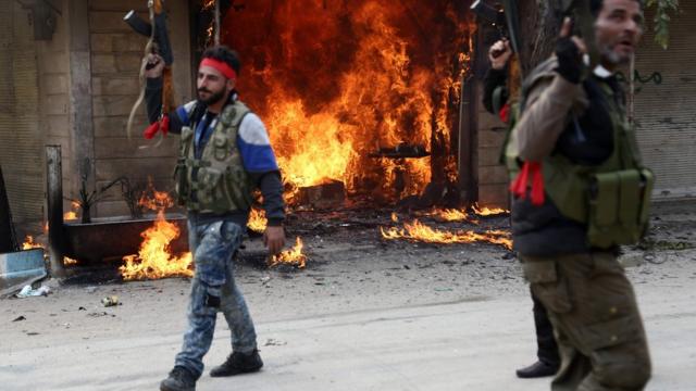 солдаты на фоне горящего магазина в Африне