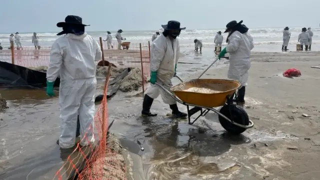 Tres mujeres limpian crudo en Playa Cavero.