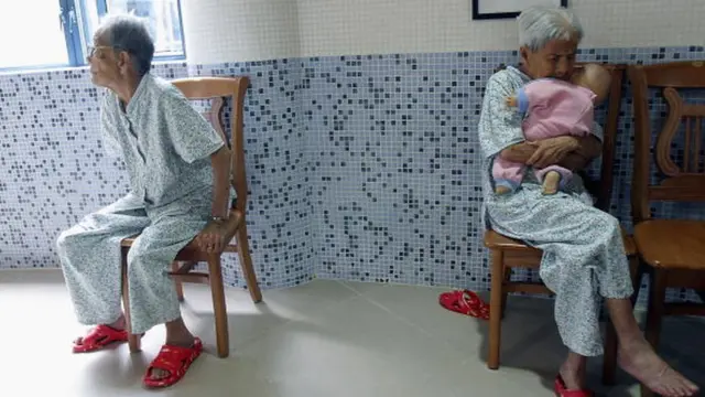 பொம்மையை கொஞ்சும் முதியோர்