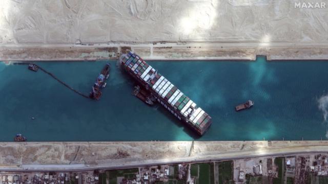 A handout satellite image made available by Maxar Technologies shows the excavation and dredging operations around the Ever Given on 28 March 2021