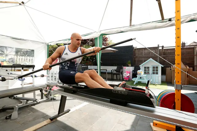 A sprint canoeist trains with equipment in his garden