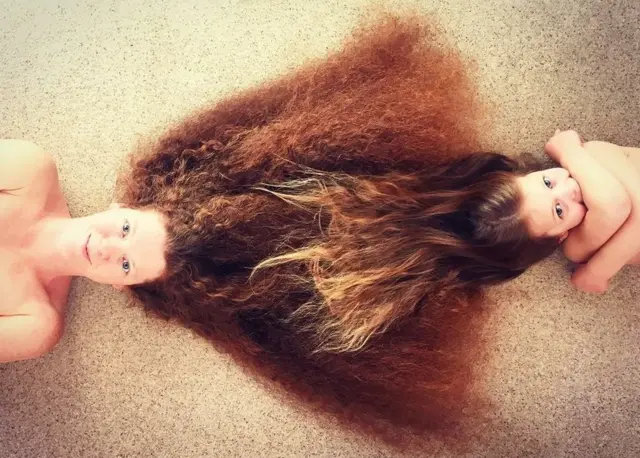 A mother and child lie on the floor