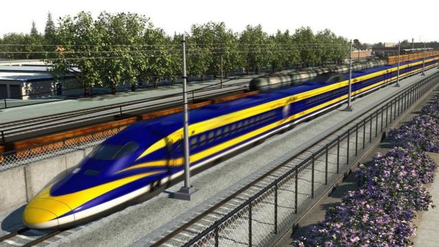 Esta es una imagen proyectada en 3D (no de la vida real) del tren de colores amarillo y azul en ruta por unos rieles en Fresno.